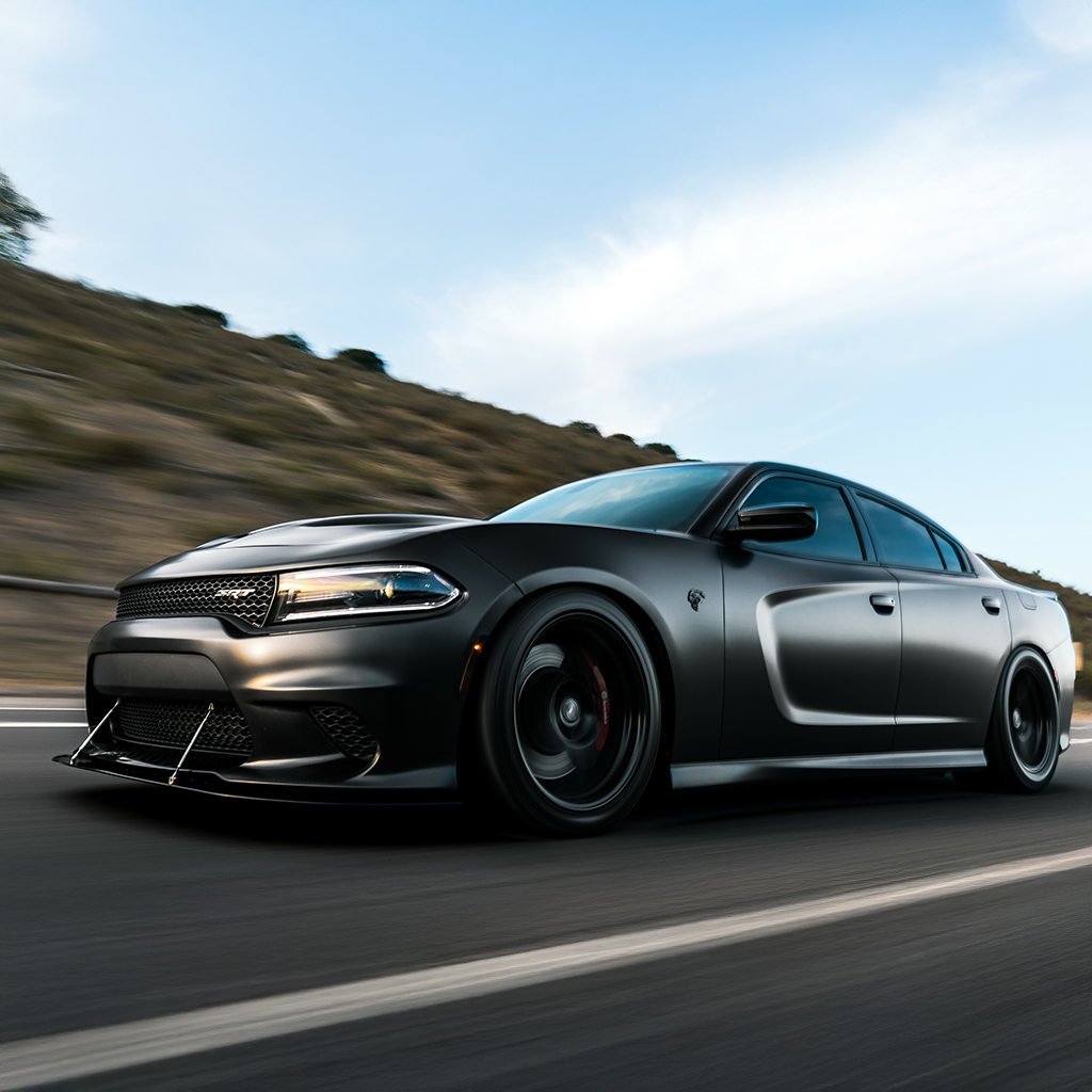 Gray sports car driving on a road with a blurred background