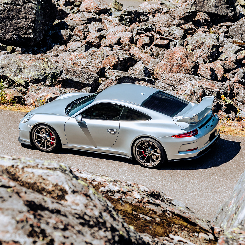 Silver sports car on a rocky road