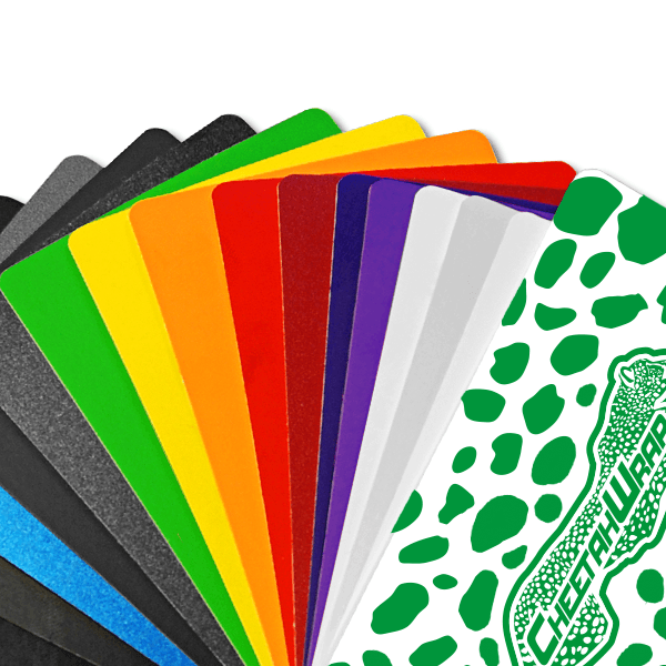 A sample book displaying various color swatches of vinyl material, with a few featuring animal print designs.