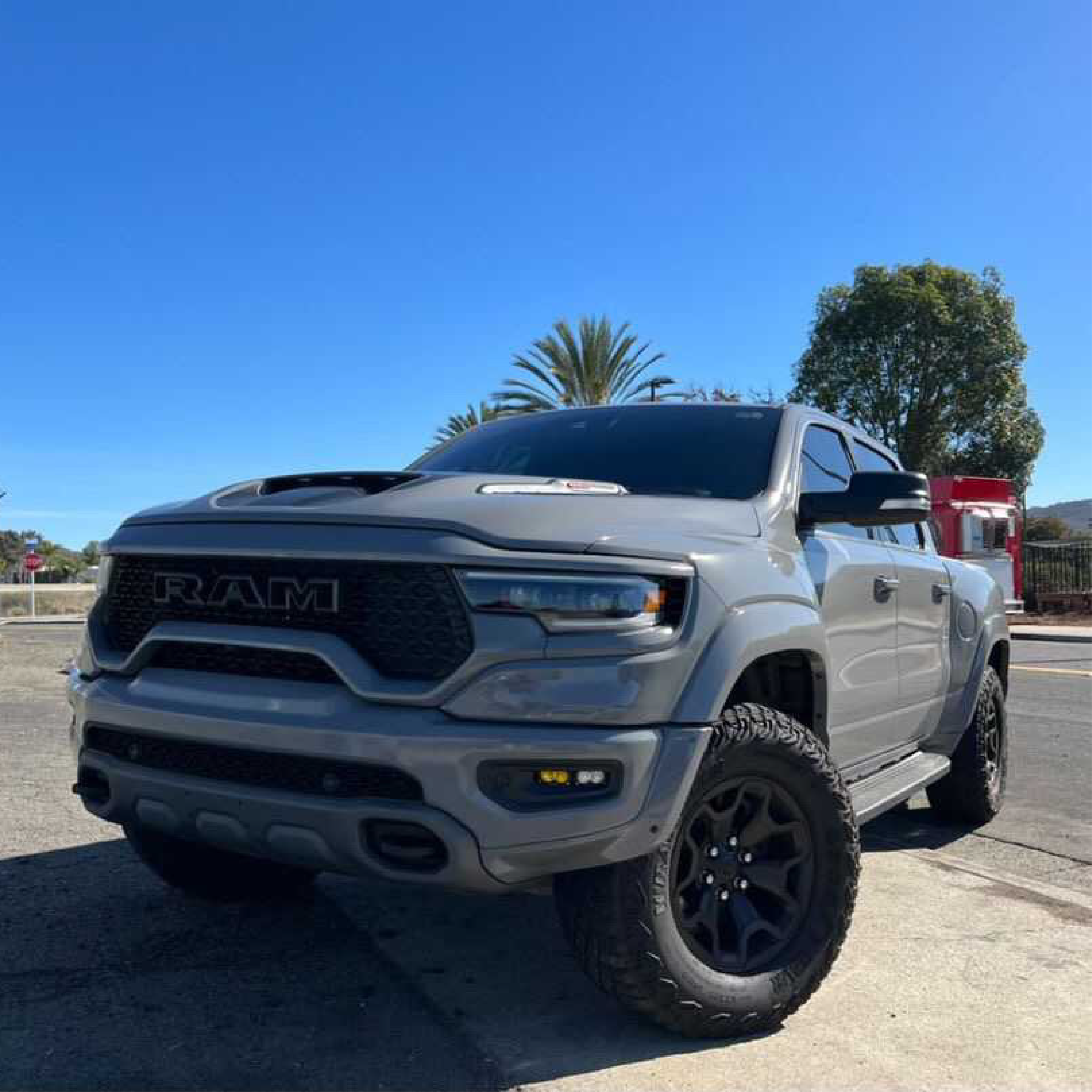 White Ram truck parked on a sunny day with palm trees in the background