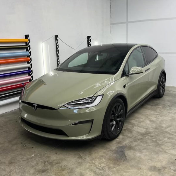 Gloss Khaki Green Vinyl Car Wrap with rich green tone and reflective finish, shown partially unrolled for vehicle wrapping application.