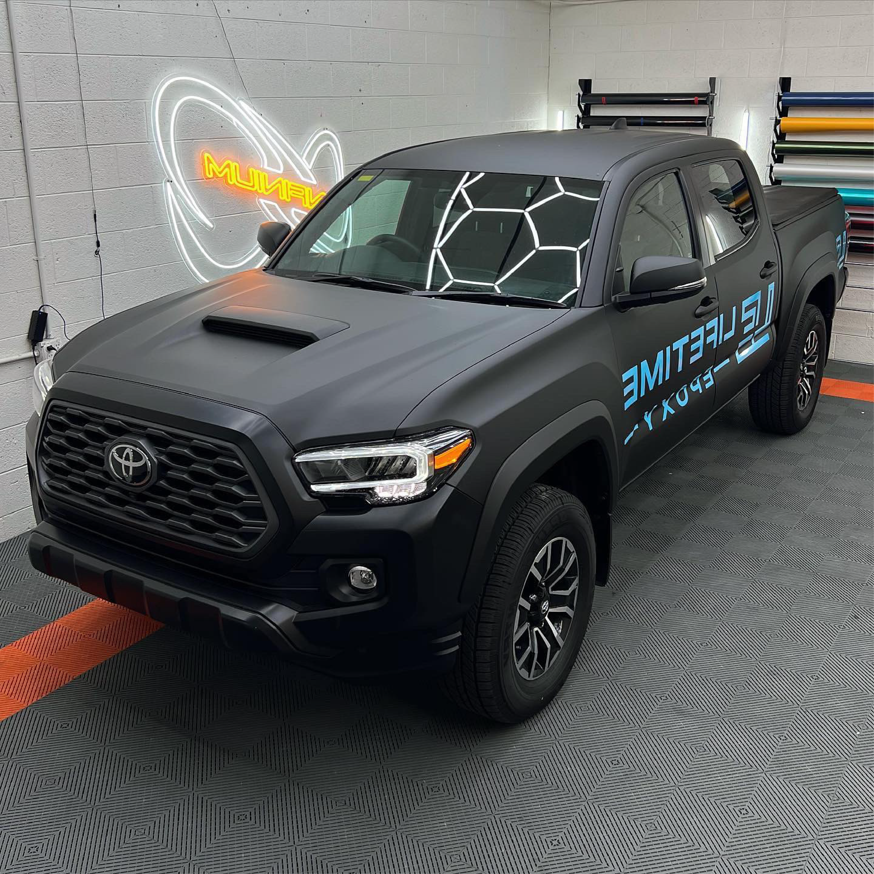 Matte Black Vinyl Car Wrap applied to vehicle, showcasing smooth non-reflective finish and deep black color for a sleek, stealth appearance