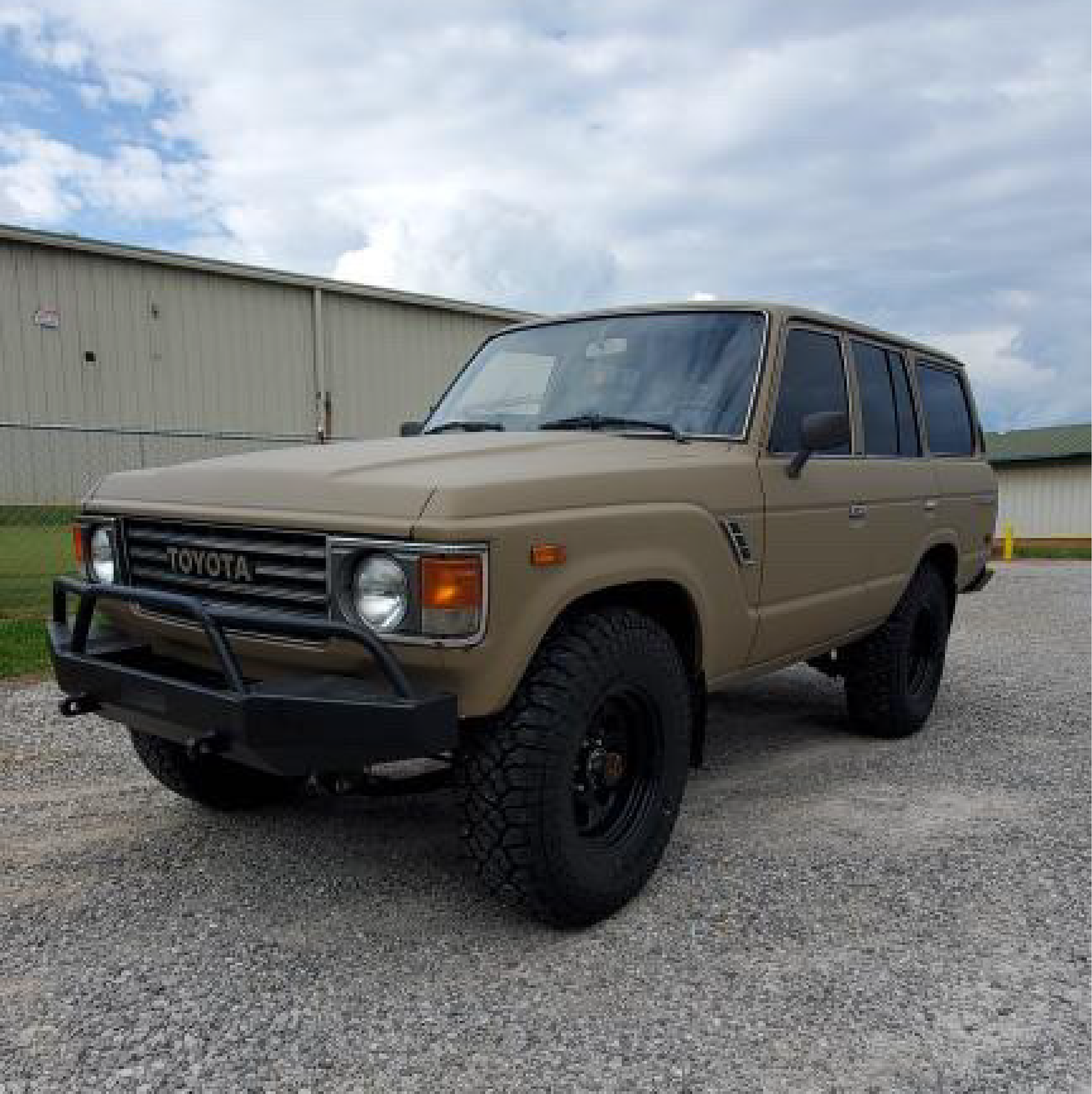 Matte Desert Tan Vinyl Car Wrap with smooth, non-glossy finish in tactical beige, shown rolled and partially unrolled for vehicle application.