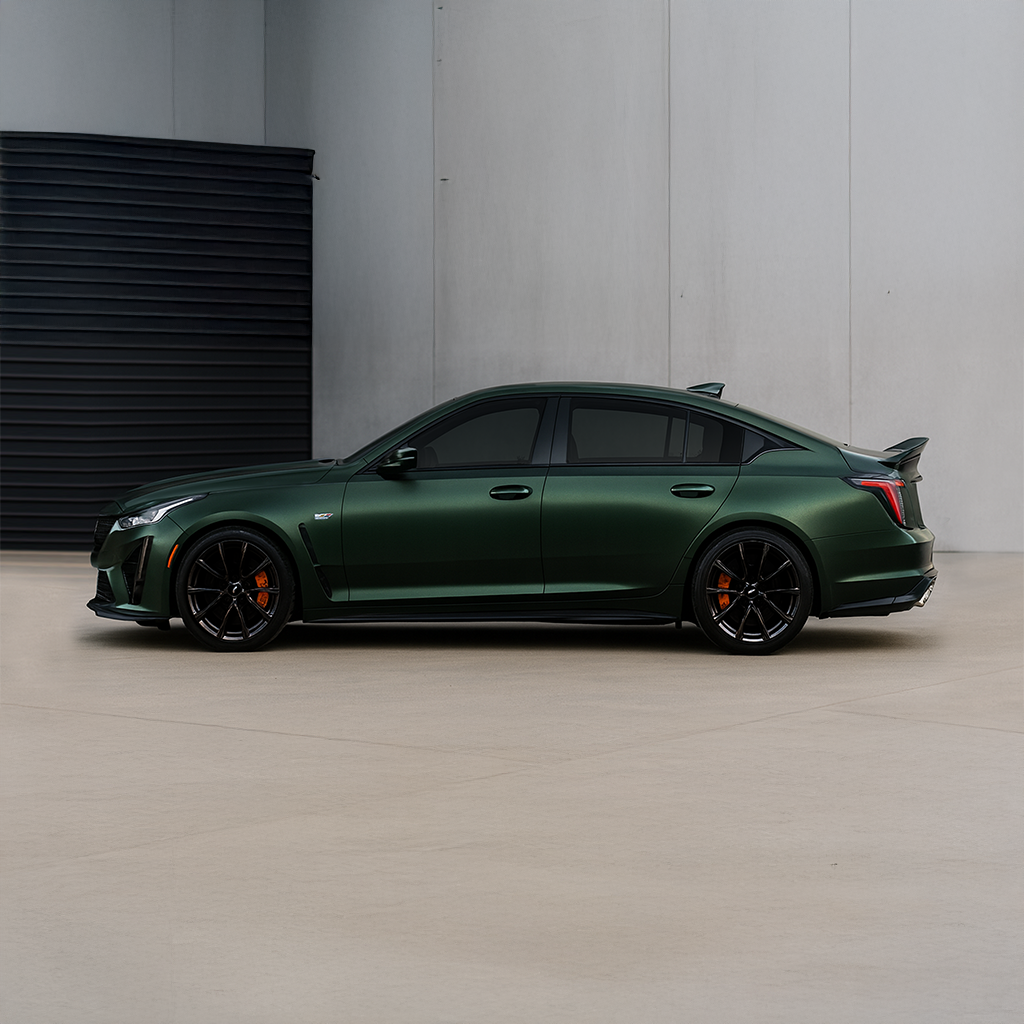 Green sports car parked in a minimalistic setting with a gray wall and floor.