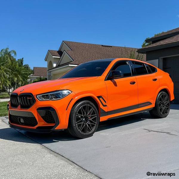 Gloss Orange Vinyl Car Wrap applied to vehicle, showcasing vibrant orange color with a smooth high-gloss finish and reflective surface