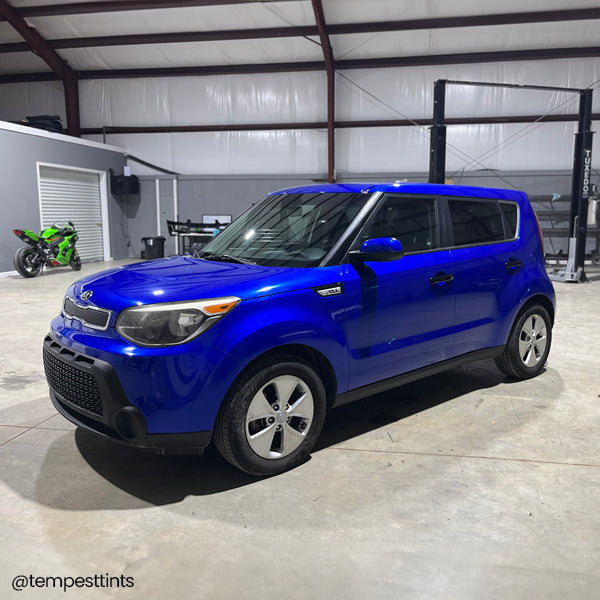 Gloss Berry Blue Vinyl Car Wrap with vibrant blue color and reflective high-gloss finish, shown partially unrolled for vehicle application.