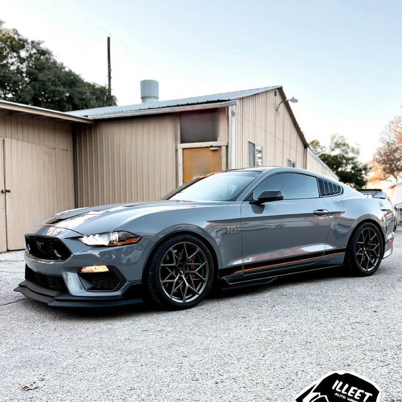 Gray Mustang sports car parked in front of a building