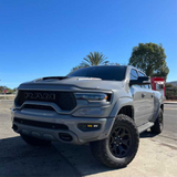 White Ram truck parked on a sunny day with palm trees in the background