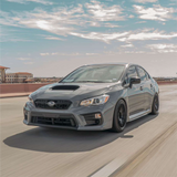Gray Subaru car on a road with a clear sky