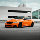 Gloss Orange Vinyl Car Wrap applied to vehicle, showcasing vibrant orange color with a smooth high-gloss finish and reflective surface