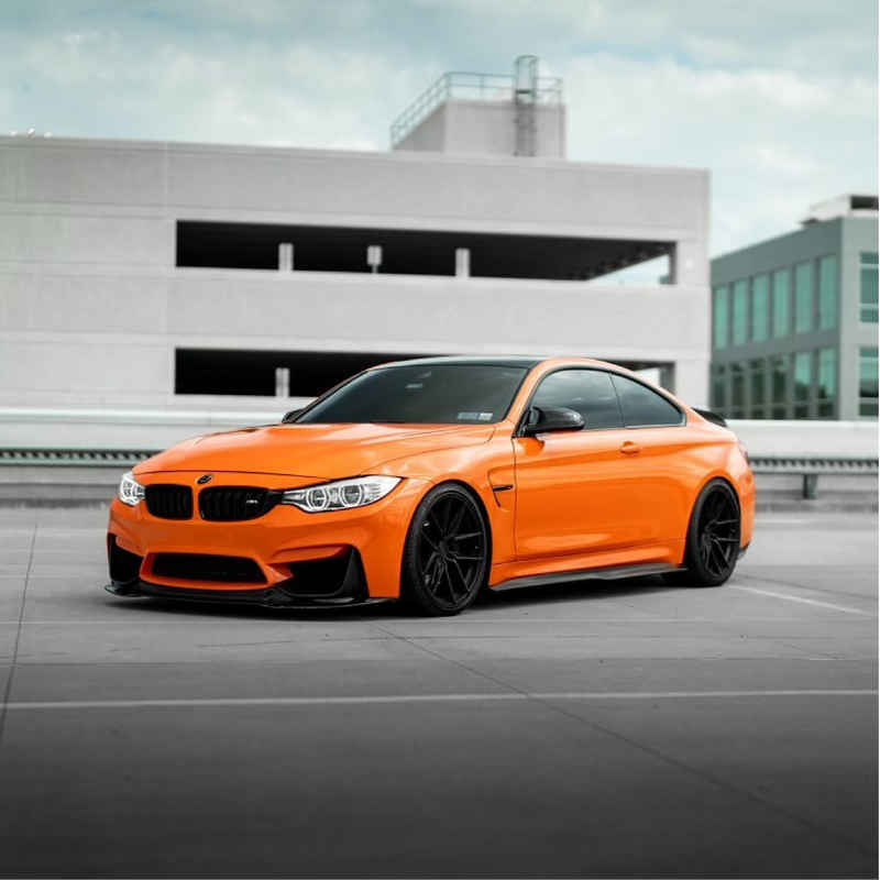 Gloss Orange Vinyl Car Wrap applied to vehicle, showcasing vibrant orange color with a smooth high-gloss finish and reflective surface