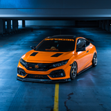 Gloss Orange Vinyl Car Wrap applied to vehicle, showcasing vibrant orange color with a smooth high-gloss finish and reflective surface