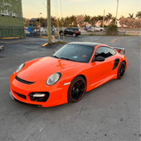 Gloss Orange Vinyl Car Wrap applied to vehicle, showcasing vibrant orange color with a smooth high-gloss finish and reflective surface