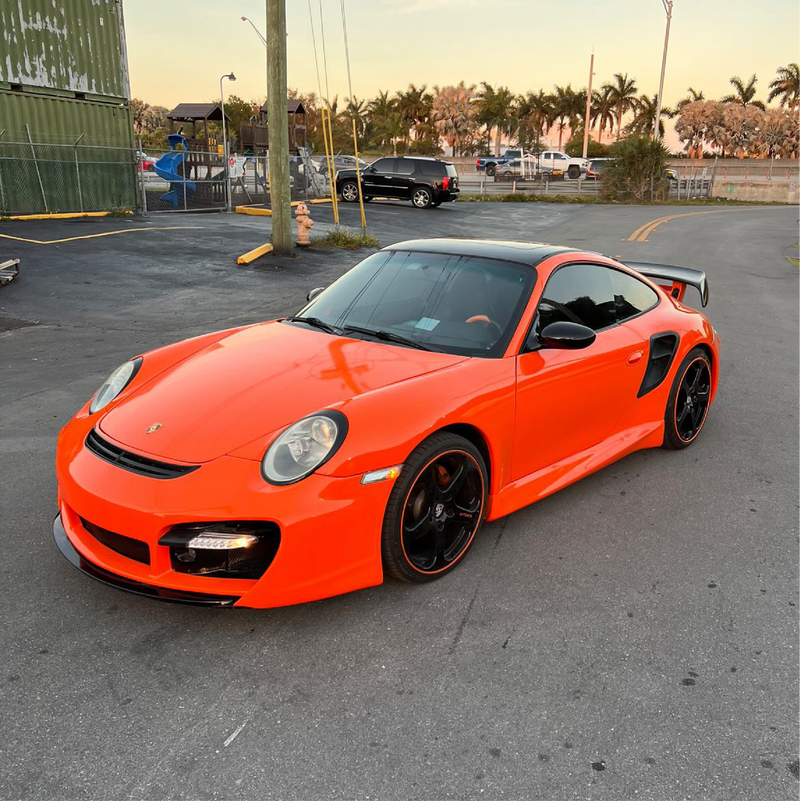 Gloss Orange Vinyl Car Wrap applied to vehicle, showcasing vibrant orange color with a smooth high-gloss finish and reflective surface
