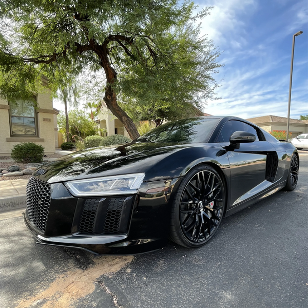 Gloss Black Vinyl Car Wrap applied to vehicle, showcasing deep black color with a smooth high-gloss finish and mirror-like reflective surface