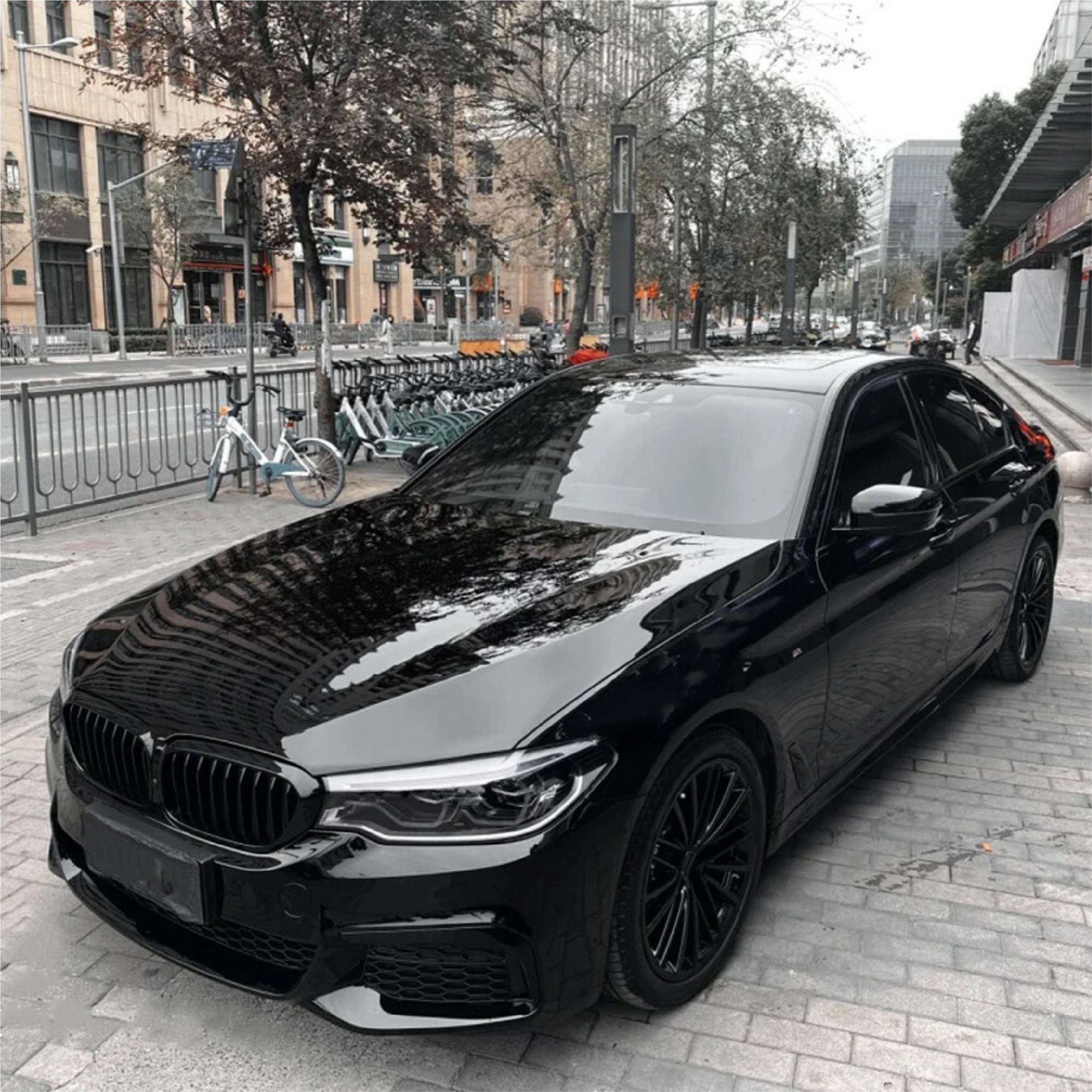 Gloss Black Metallic Vinyl Car Wrap applied to vehicle, showcasing deep black color with metallic flake and a smooth high-gloss reflective finish
