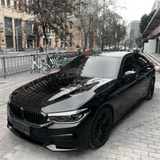 Gloss Black Metallic Vinyl Car Wrap applied to vehicle, showcasing deep black color with metallic flake and a smooth high-gloss reflective finish

