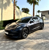 Gloss Black Metallic Vinyl Car Wrap applied to vehicle, showcasing deep black color with metallic flake and a smooth high-gloss reflective finish
