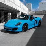 Gloss Light Blue Vinyl Car Wrap applied to vehicle, showcasing soft sky-blue color with a smooth high-gloss finish and reflective surface