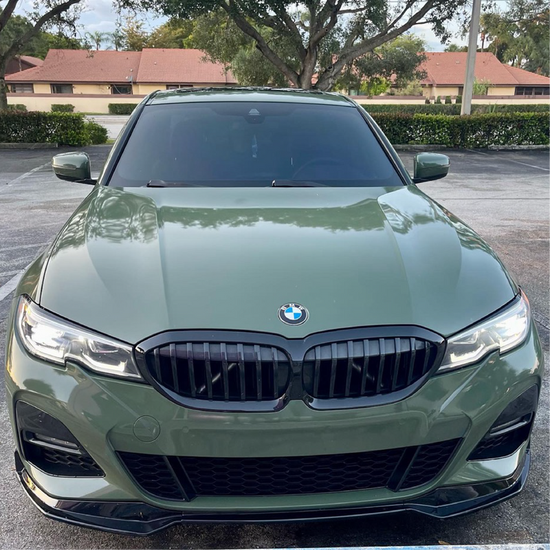 Gloss Military Green Vinyl Car Wrap applied to vehicle, showcasing rich army green color with a smooth, high-gloss finish and reflective surface