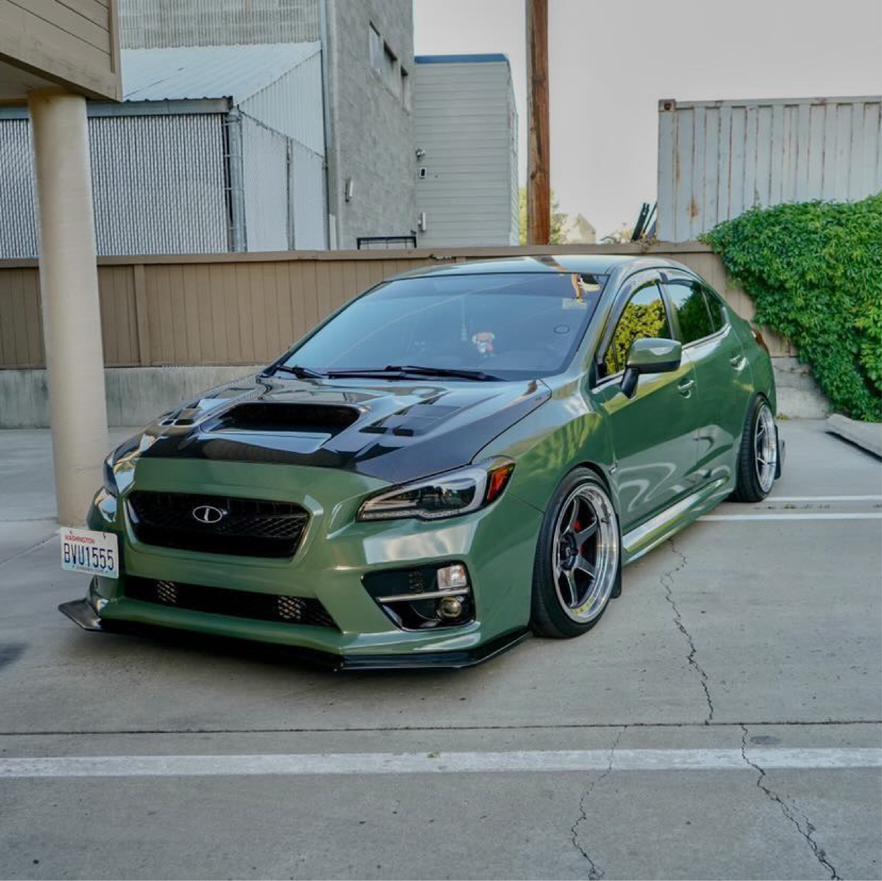 Gloss Military Green Vinyl Car Wrap applied to vehicle, showcasing rich army green color with a smooth, high-gloss finish and reflective surface