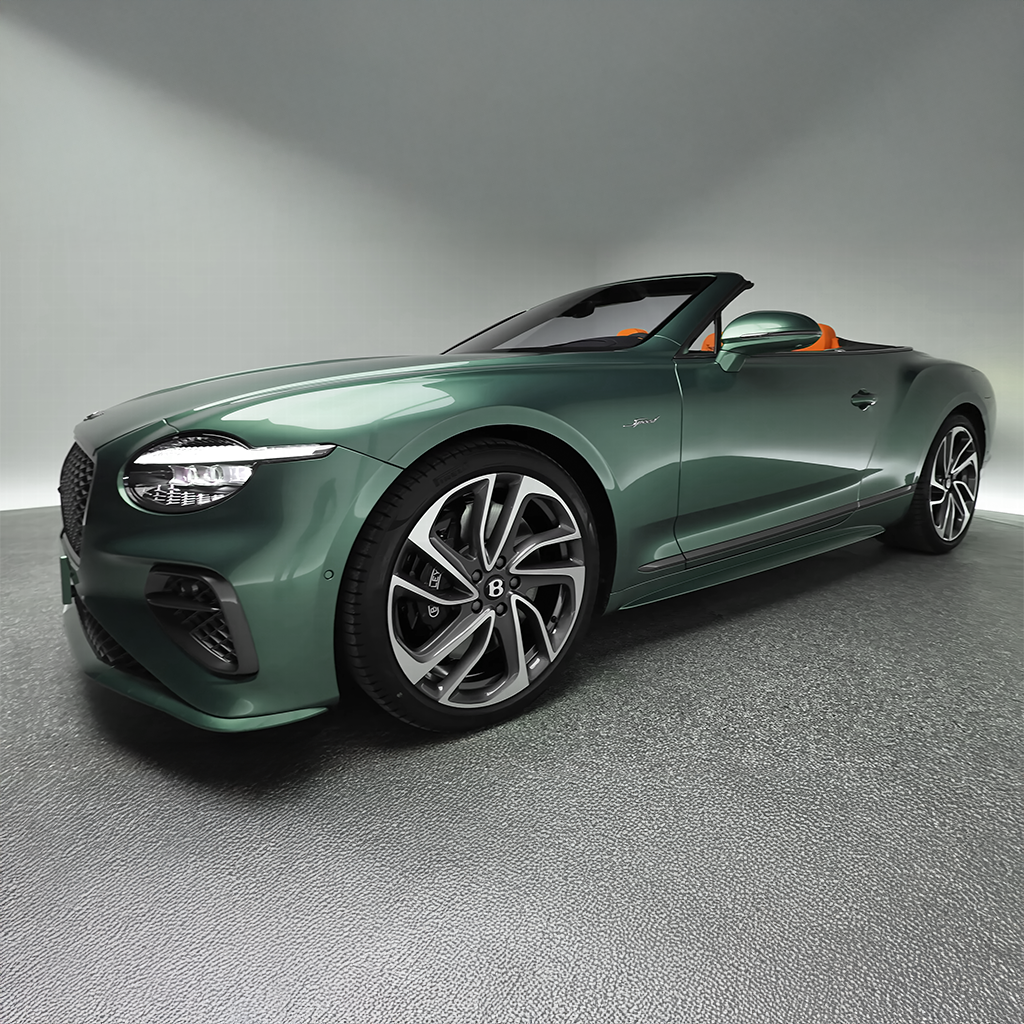 Green convertible car on a gray floor with a neutral background