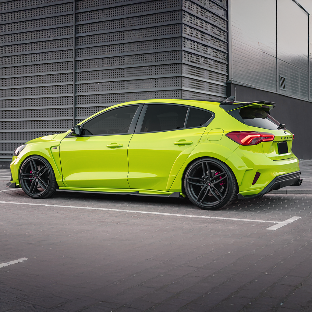 Lime green car parked on a street with a modern building in the background