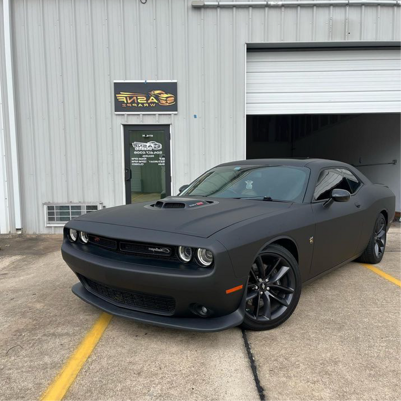 Matte Black Vinyl Car Wrap applied to vehicle, showcasing smooth non-reflective finish and deep black color for a sleek, stealth appearance