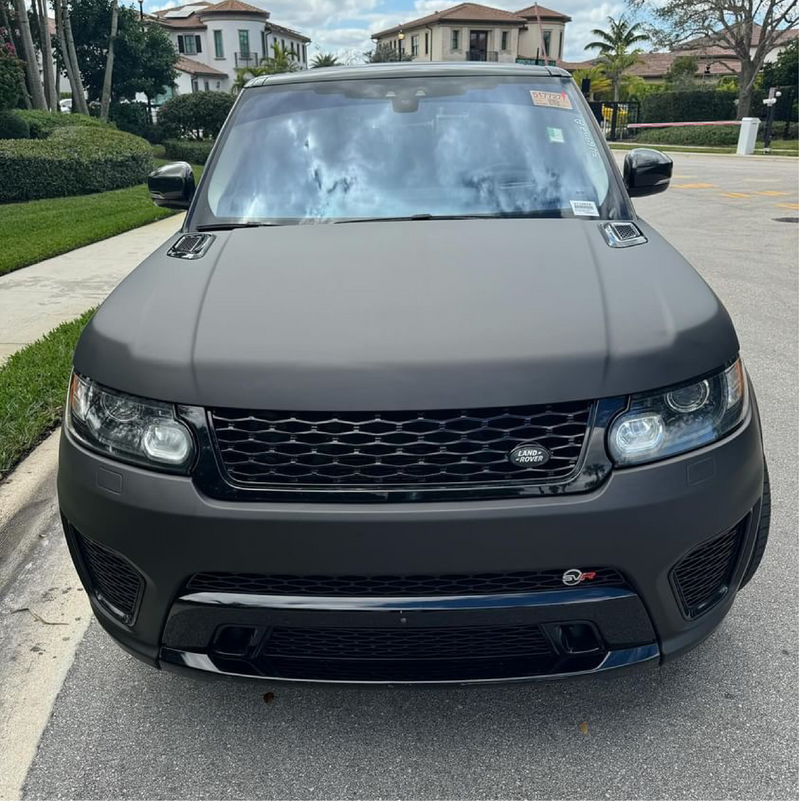 Matte Black Vinyl Car Wrap applied to vehicle, showcasing smooth non-reflective finish and deep black color for a sleek, stealth appearance