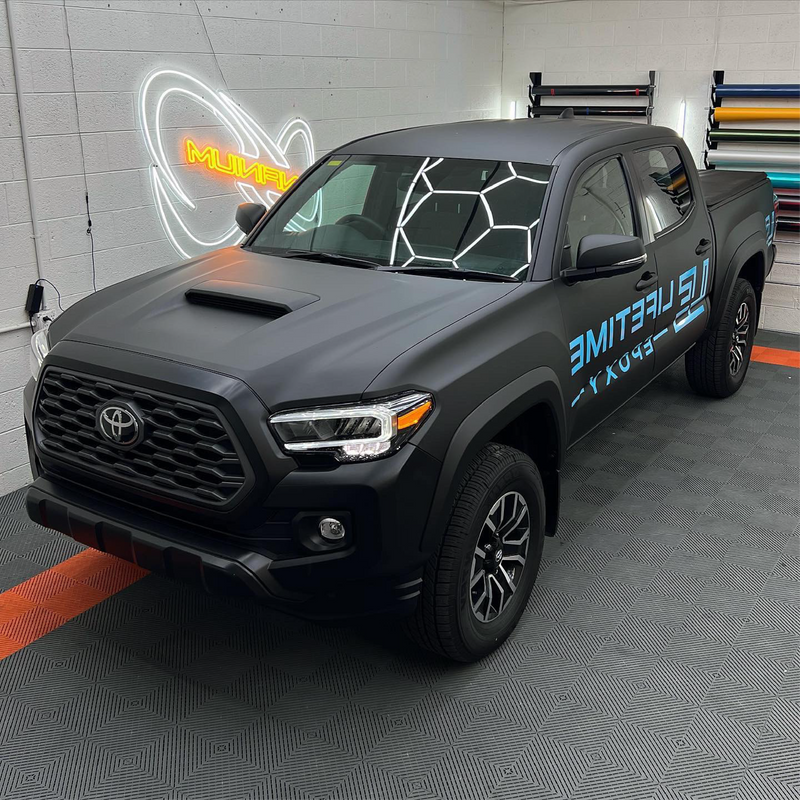 Matte Black Vinyl Car Wrap applied to vehicle, showcasing smooth non-reflective finish and deep black color for a sleek, stealth appearance