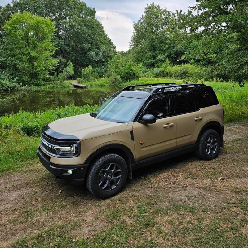 Matte Desert Tan Vinyl Car Wrap with smooth, non-glossy finish in tactical beige, shown rolled and partially unrolled for vehicle application.  