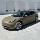 Matte Desert Tan Vinyl Car Wrap with smooth, non-glossy finish in tactical beige, shown rolled and partially unrolled for vehicle application.  