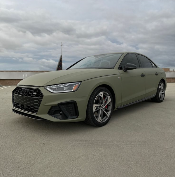 Matte Khaki Green Vinyl Car Wrap with non-reflective military green finish, shown partially unrolled for vehicle wrap application.  
