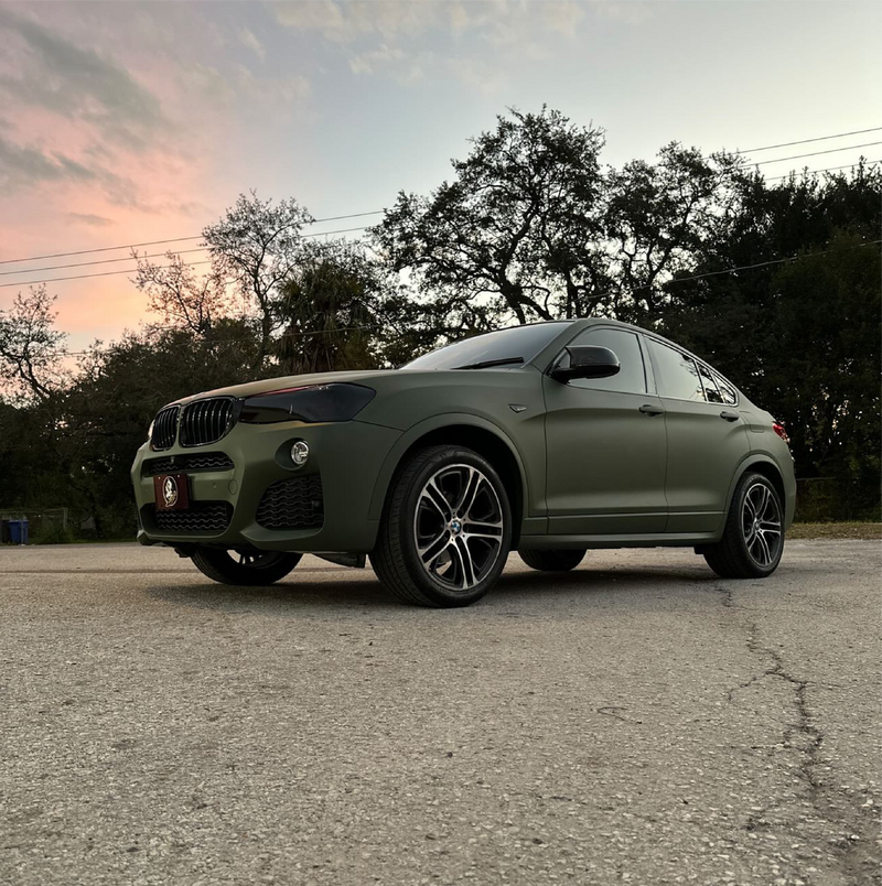 Matte Military Green Vinyl Car Wrap applied to vehicle, featuring a deep tactical green color with smooth matte finish and rugged, non-reflective appearance