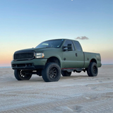 Matte Military Green Vinyl Car Wrap applied to vehicle, featuring a deep tactical green color with smooth matte finish and rugged, non-reflective appearance