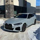 Matte Nardo Gray BMW car parked in front of a building with snow on the ground