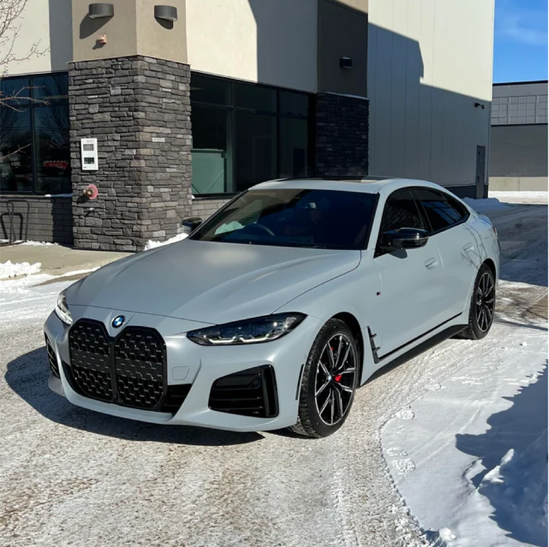 Matte Nardo Gray BMW car parked in front of a building with snow on the ground