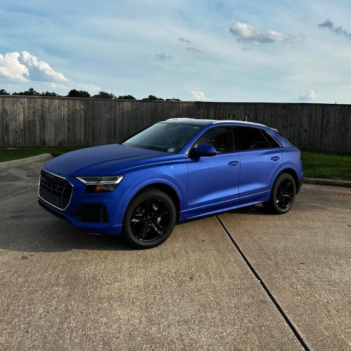 Close-up of Satin Berry Blue Aluminum Vinyl Car Wrap with smooth satin finish and metallic sheen, displayed rolled and partially unrolled.
