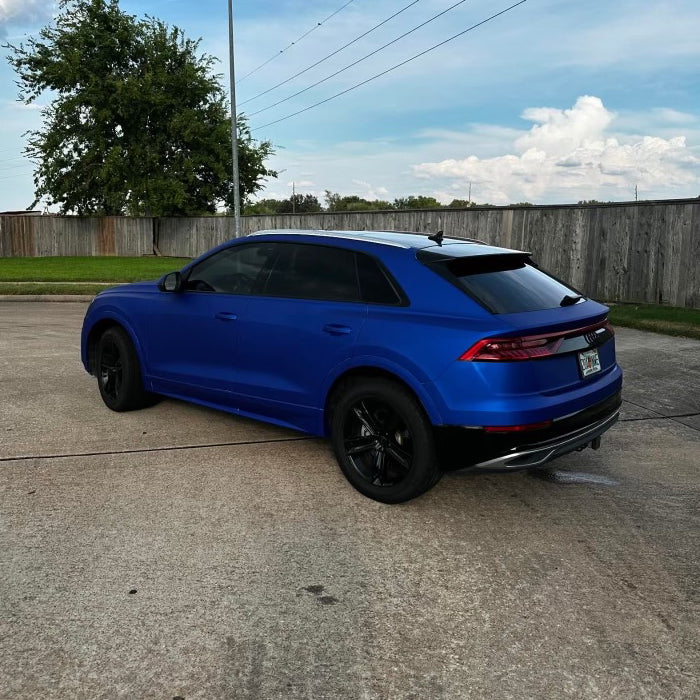 Close-up of Satin Berry Blue Aluminum Vinyl Car Wrap with smooth satin finish and metallic sheen, displayed rolled and partially unrolled.
