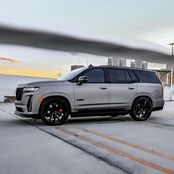 Gray SUV parked on a road with a blurred background