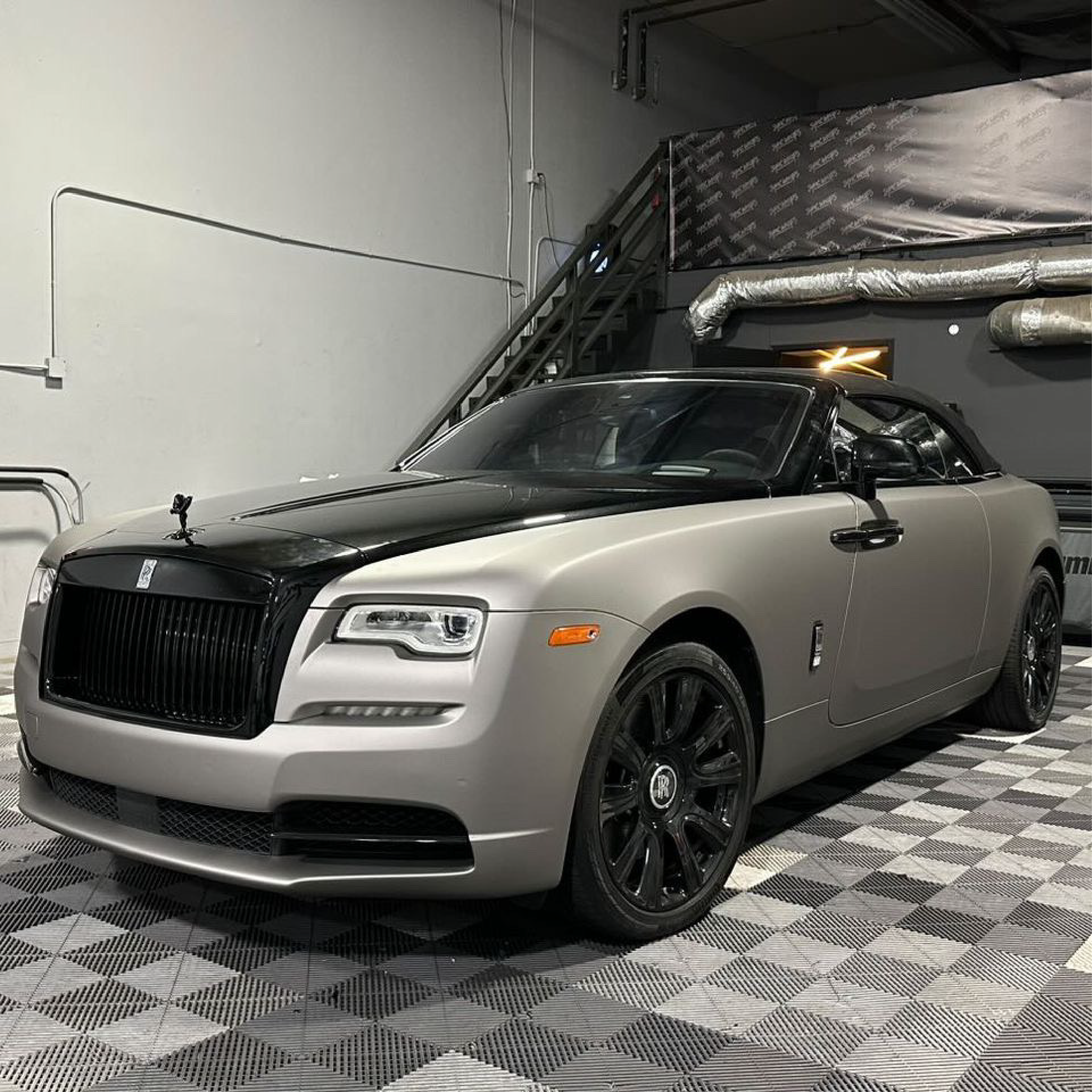 Luxury car parked in a garage with checkered floor