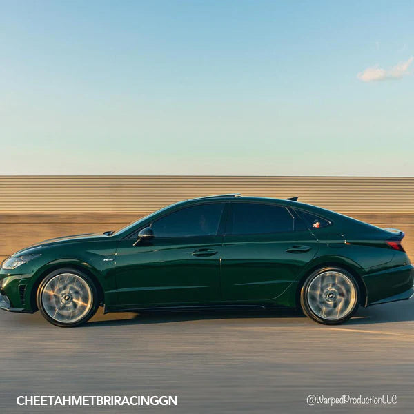 Gloss British Racing Green Metallic Vinyl Car Wrap with deep green color and high-gloss metallic finish, shown partially unrolled for vehicle application.  
